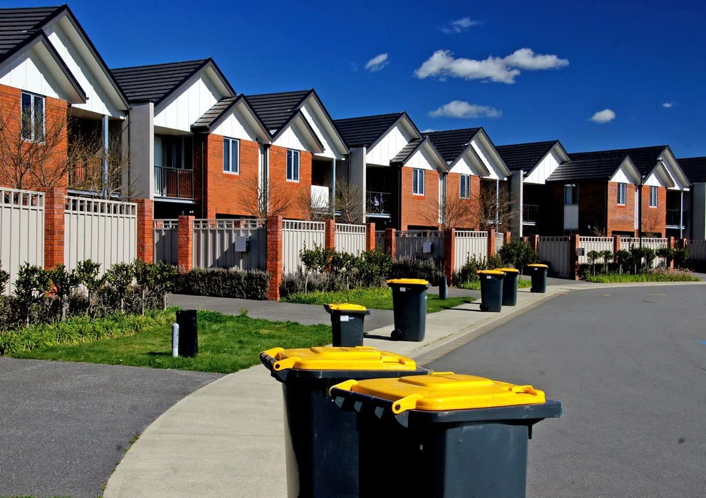 Terrace of new brick and render townhouses with pitched roofs